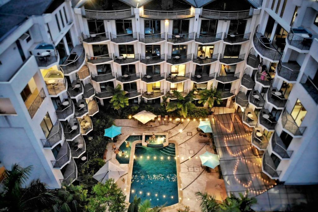 Hotel Oceano Boutique Suites in Jaco, Costa Rica with modern balconies, swimming pool, and evening lights